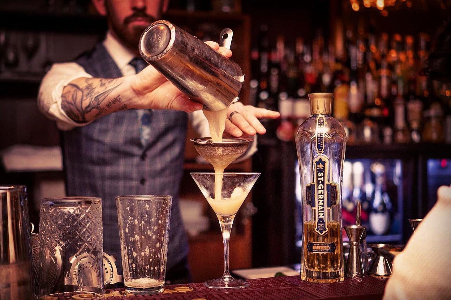 A bartender expertly makes a drink at The Bunker, one of the best bars in Queenstown.